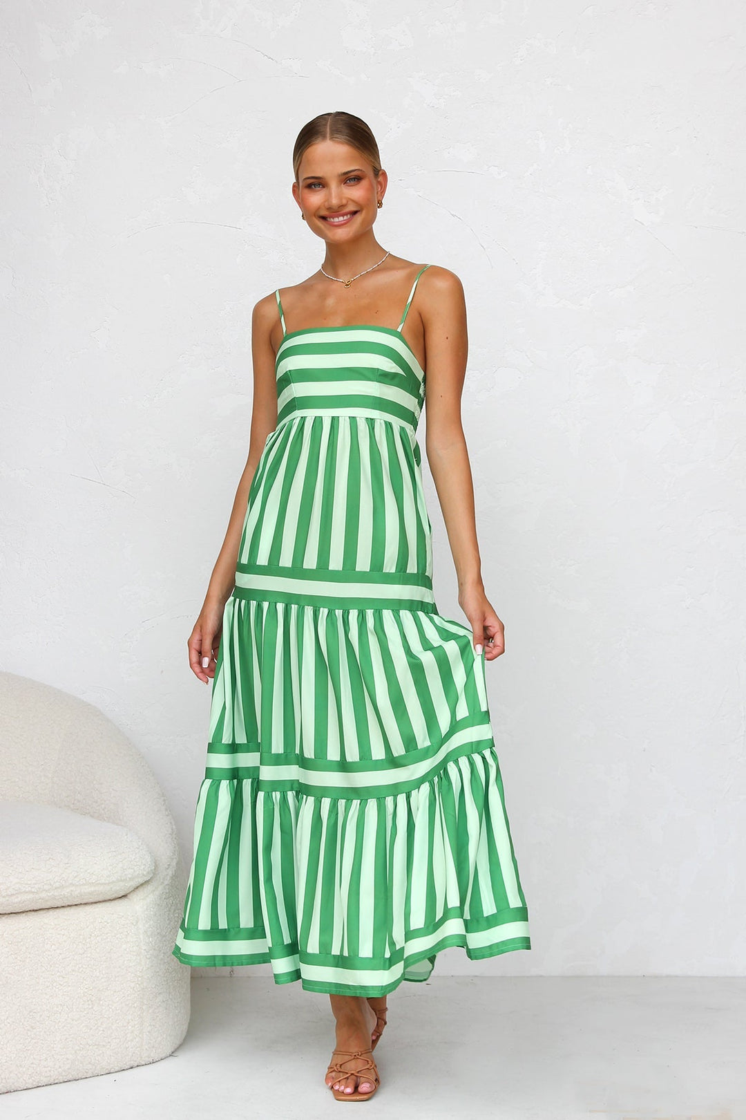 Women's striped tiered maxi dress with spaghetti straps, perfect for summer or casual wear.