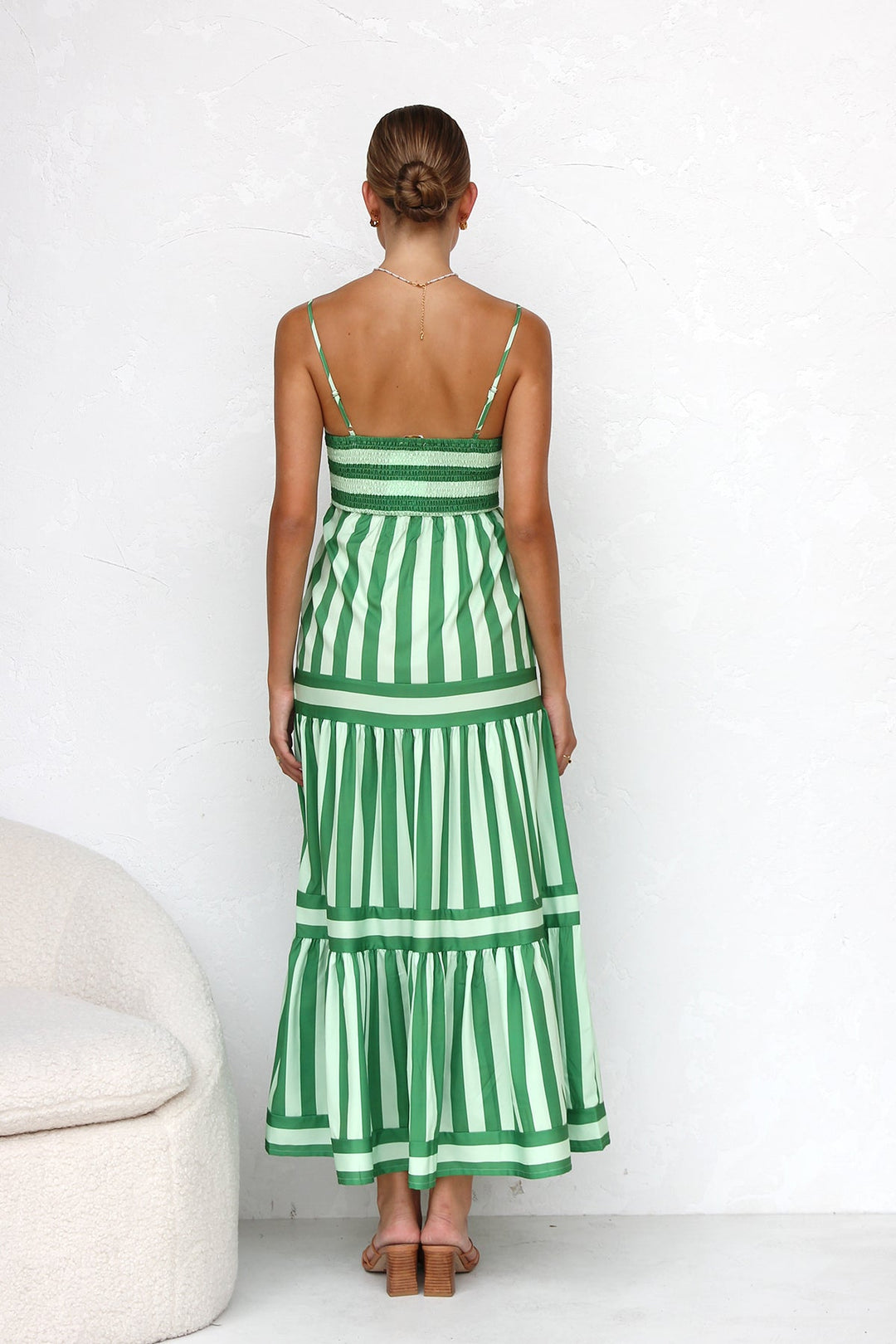 Vibrant striped tiered maxi dress for women, with spaghetti straps, perfect for beach or evening wear.