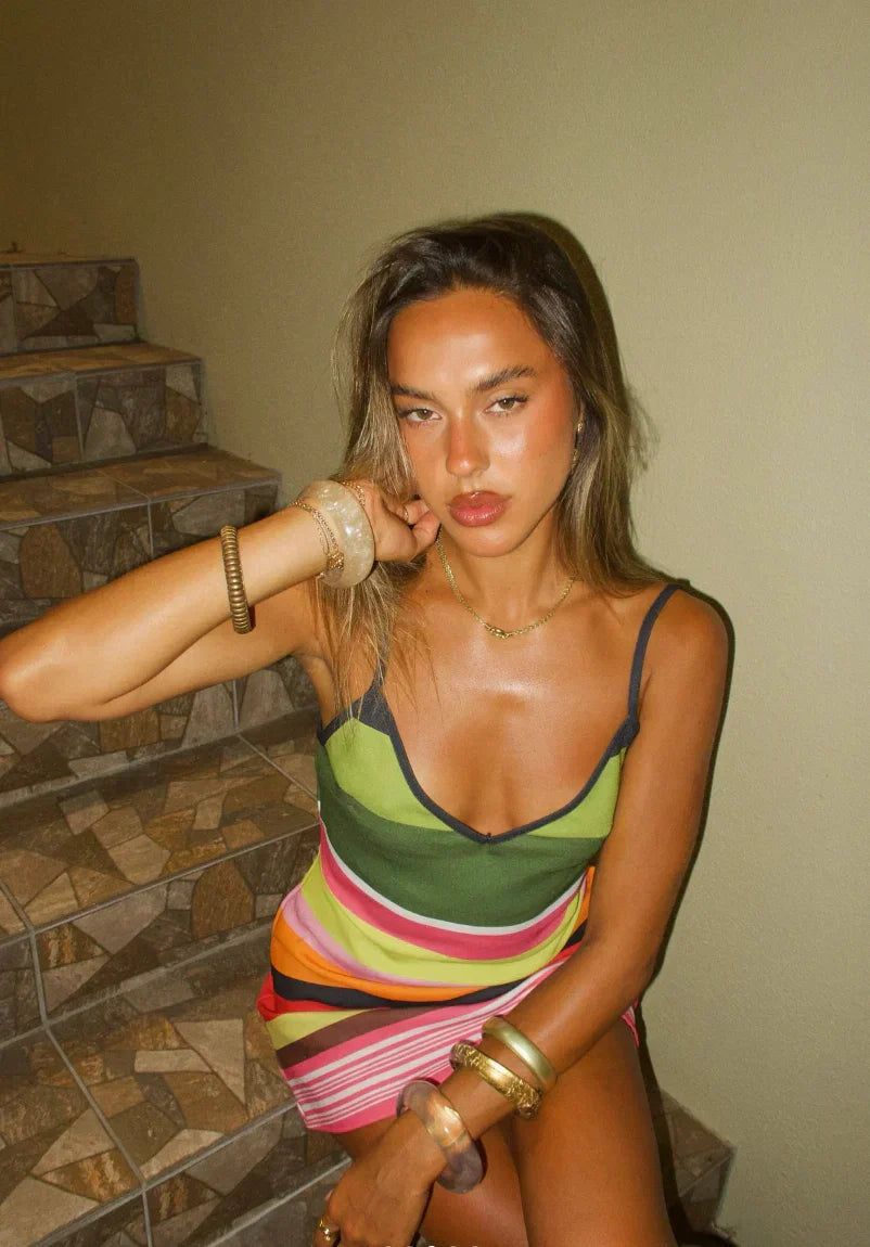 Sleeveless striped mini dress for women, featuring a flattering V-neckline and adjustable spaghetti straps for comfort.