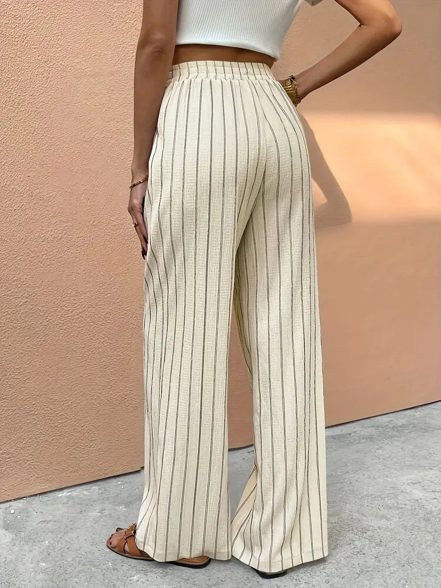 Relaxed fit women's linen wide leg pants featuring elegant stripes & comfortable elastic waist for holiday attire.