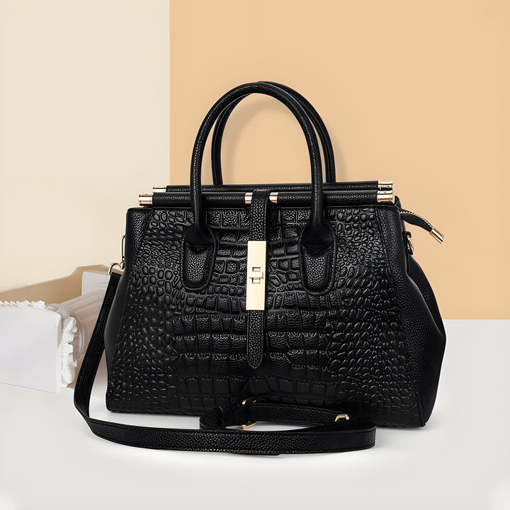 Elegant women's handbag featuring a luxurious alligator relief on structured leather. Multiple compartments.