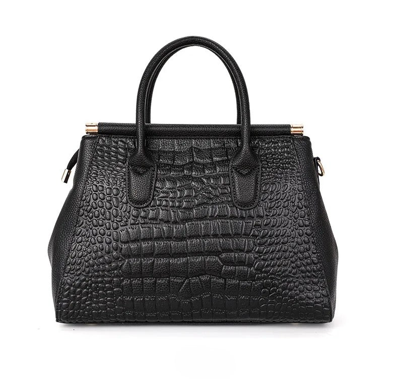 Chic women's structured leather handbag with embossed alligator pattern. A sophisticated fashion accessory.