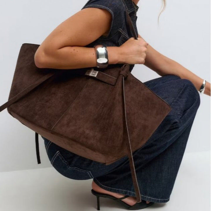High-quality women's structured shopper bag with elegant gold-tone hardware, a chic fashion statement.