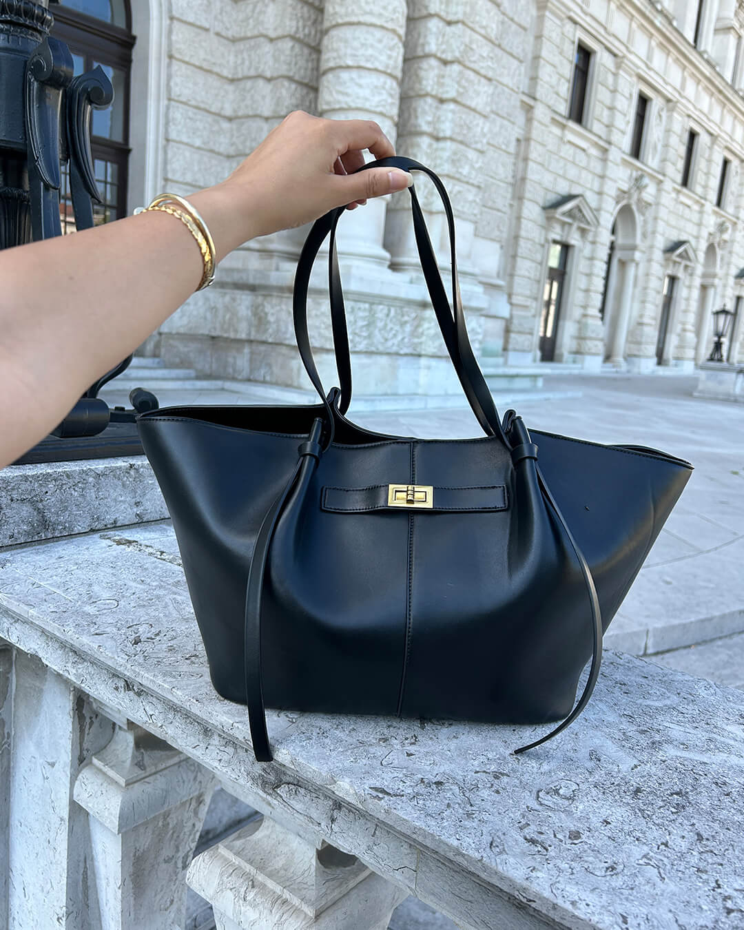 Stylish women's structured tote bag, chic gold hardware, spacious design; perfect for office.