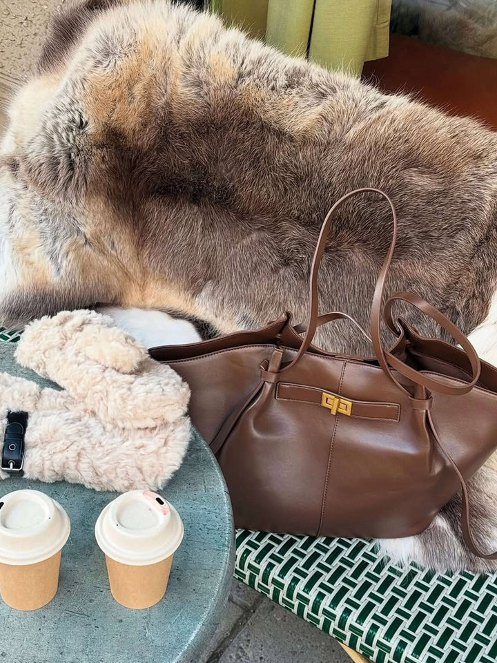 Sophisticated women's large structured tote bag, featuring elegant gold-tone hardware and sturdy build.