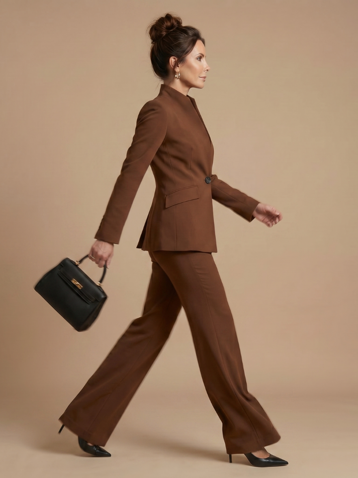 Classic navy women's tailored suit, stand collar jacket & flared trousers. Versatile professional wear.