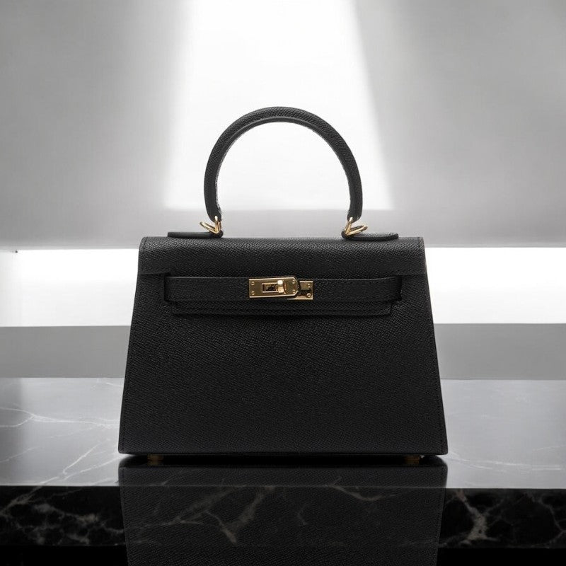 Women's structured top handle handbag with elegant gold lock. Perfect day-to-evening fashion accessory.