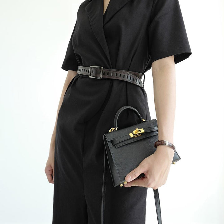 Modern structured women's handbag with a sturdy top handle and eye-catching gold lock. Everyday elegance.