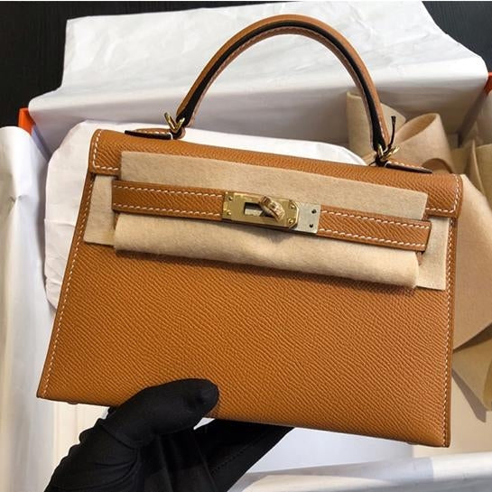 Premium women's structured bag: top handle for comfort, elegant gold lock for security and style.