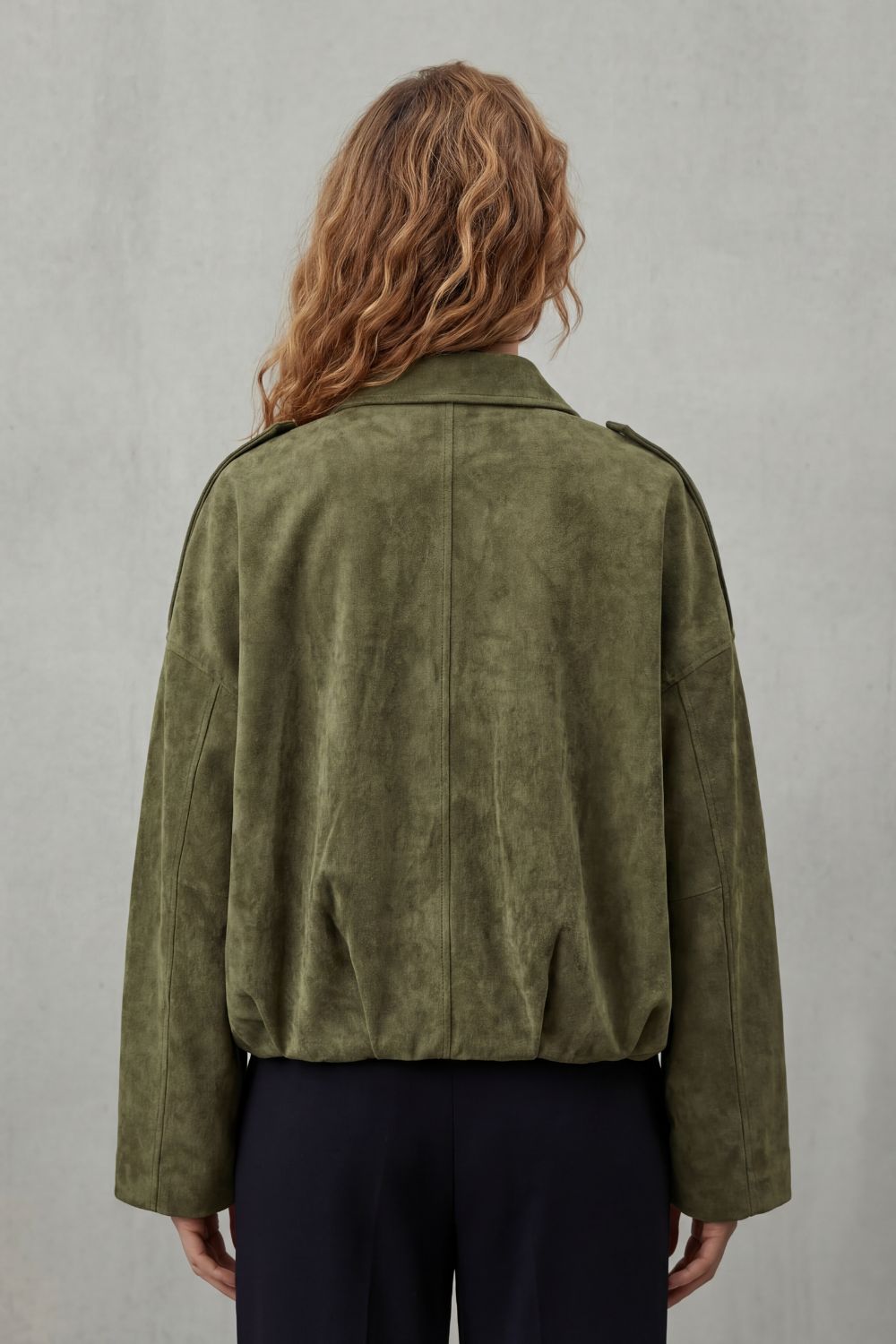 Elegant brown structured volume bomber jacket for women, offering a modern, versatile style for various occasions.