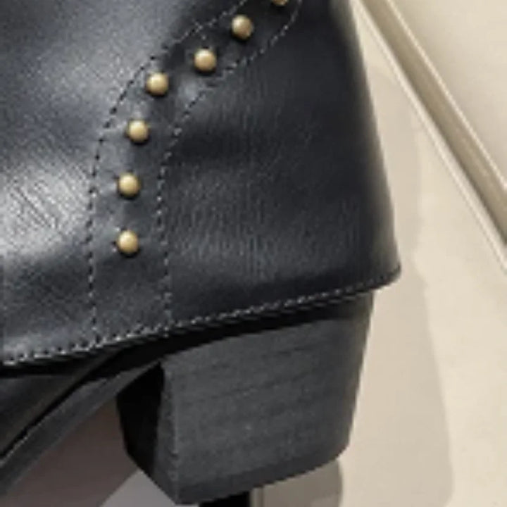 Trendy women's studded cowgirl boots, pointed toe, mid-calf height, for a modern western look.