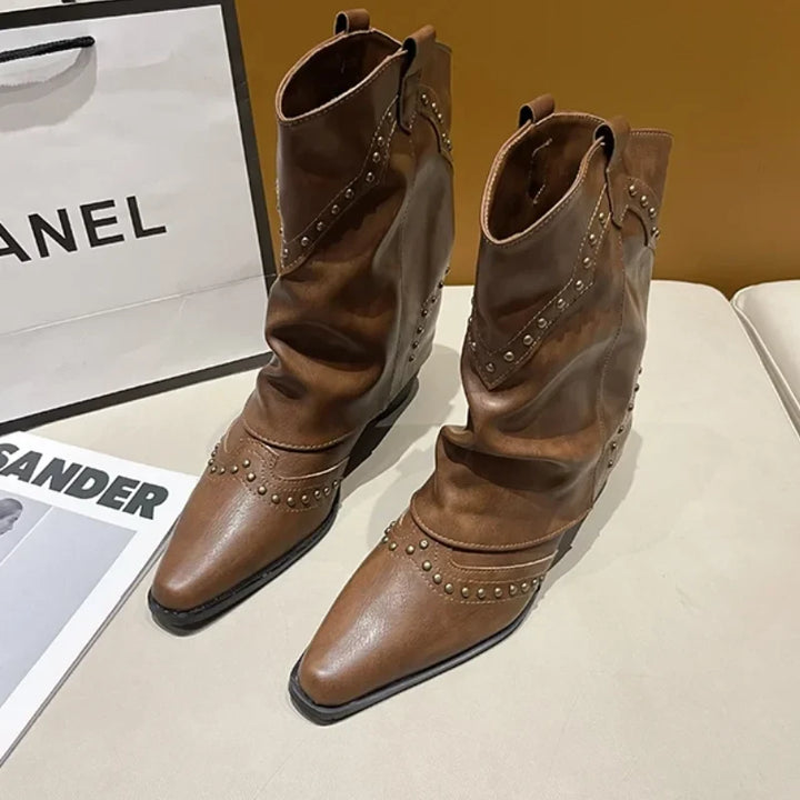 Brown studded women's boots, block heel, pointed toe, making a strong fashion statement.