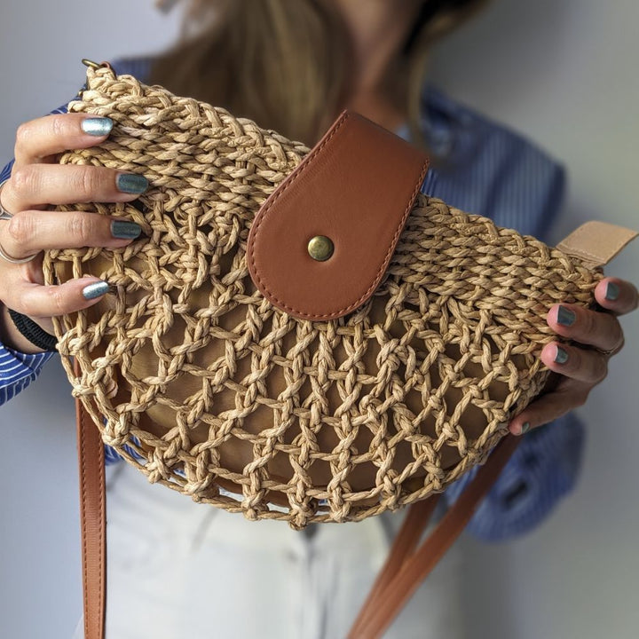 Bohemian braided straw crossbody bag for women, a stylish and lightweight summer accessory.