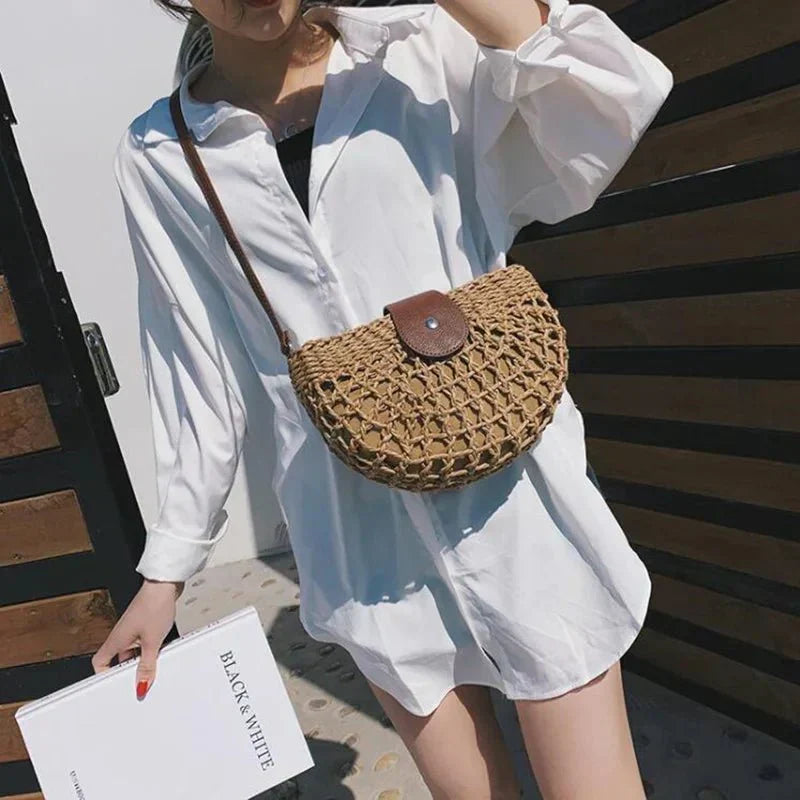 Lightweight women's braided straw handbag, perfect as a crossbody for summer or a beach bag.
