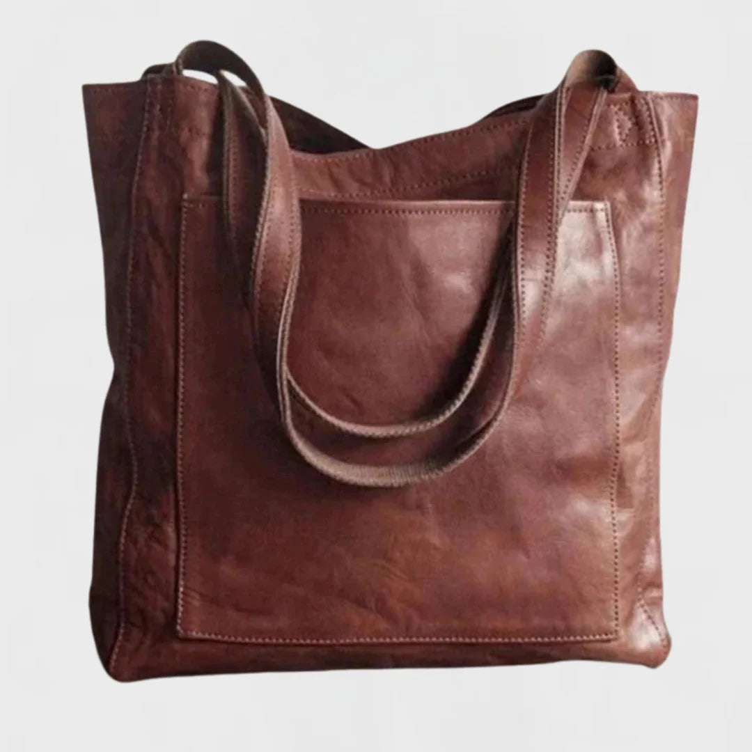 Elegant coffee leather tote bag for women, featuring a practical front pocket & comfortable shoulder straps.