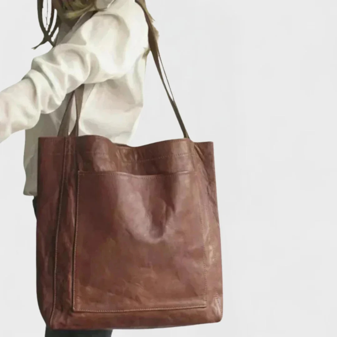 Spacious women's brown leather shoulder bag, a stylish everyday tote with an accessible front pocket.