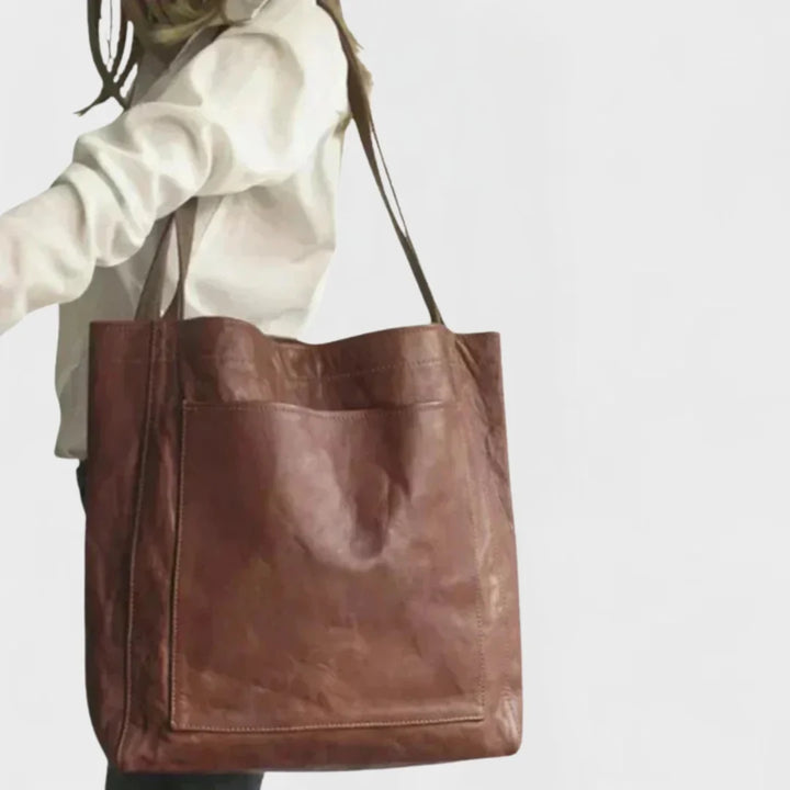 Spacious women's brown leather shoulder bag, a stylish everyday tote with an accessible front pocket.