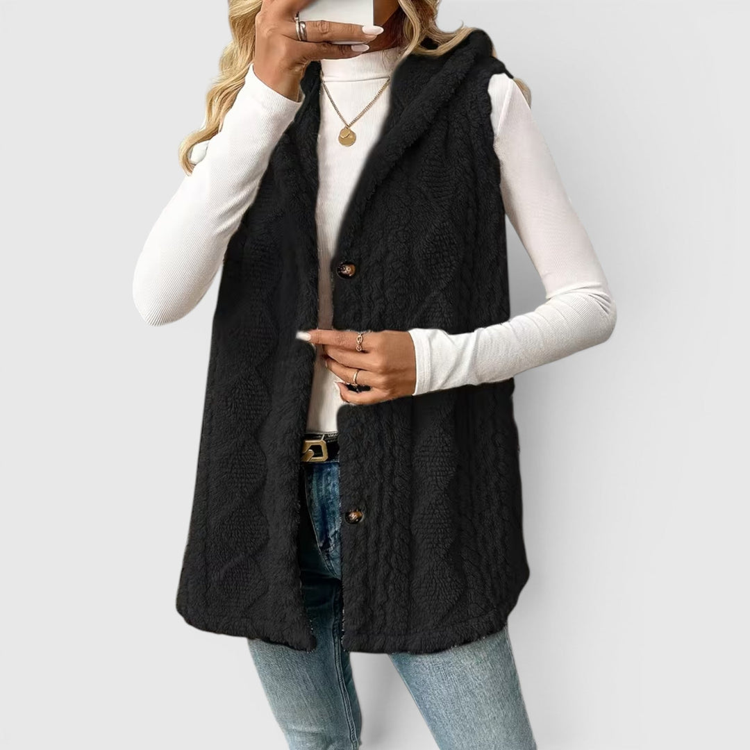 Cozy women's button-front hooded vest, essential for stylish transitional wear.