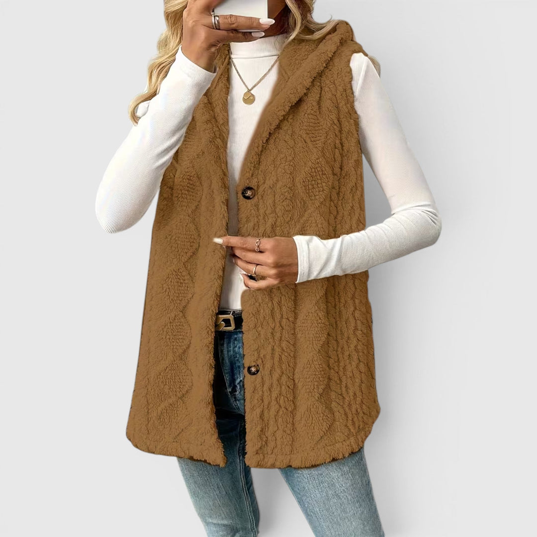 Versatile women's sleeveless hooded vest, button-front for a modern outerwear look.