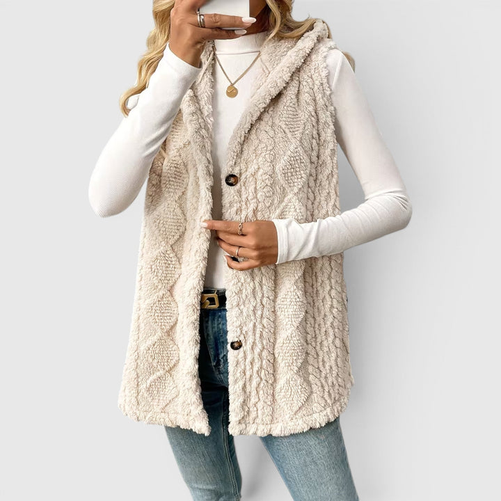 Stylish women's button-front vest, hooded for warmth & versatile wear.