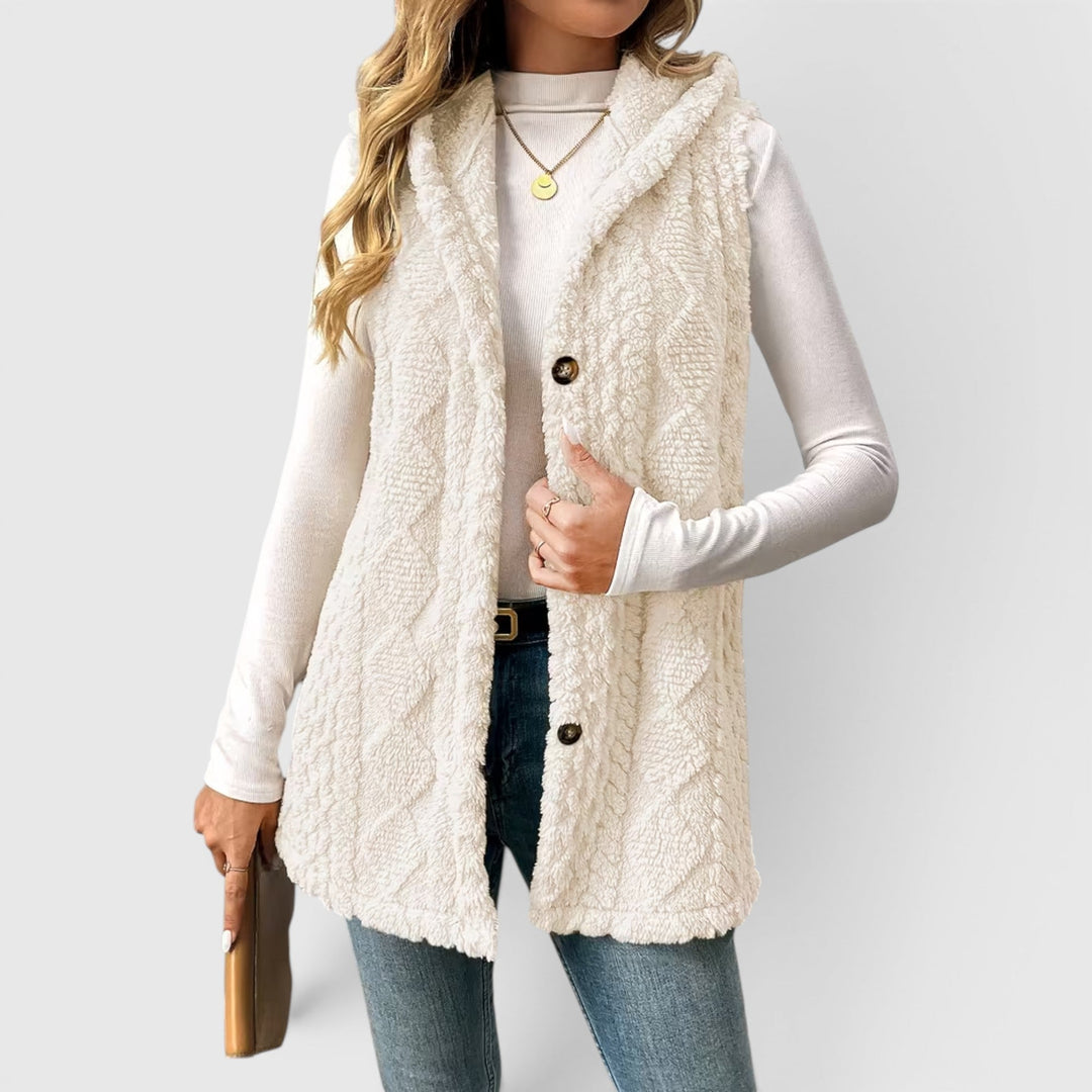 Transitional women's hooded vest outerwear, sleeveless & button-up for comfort.