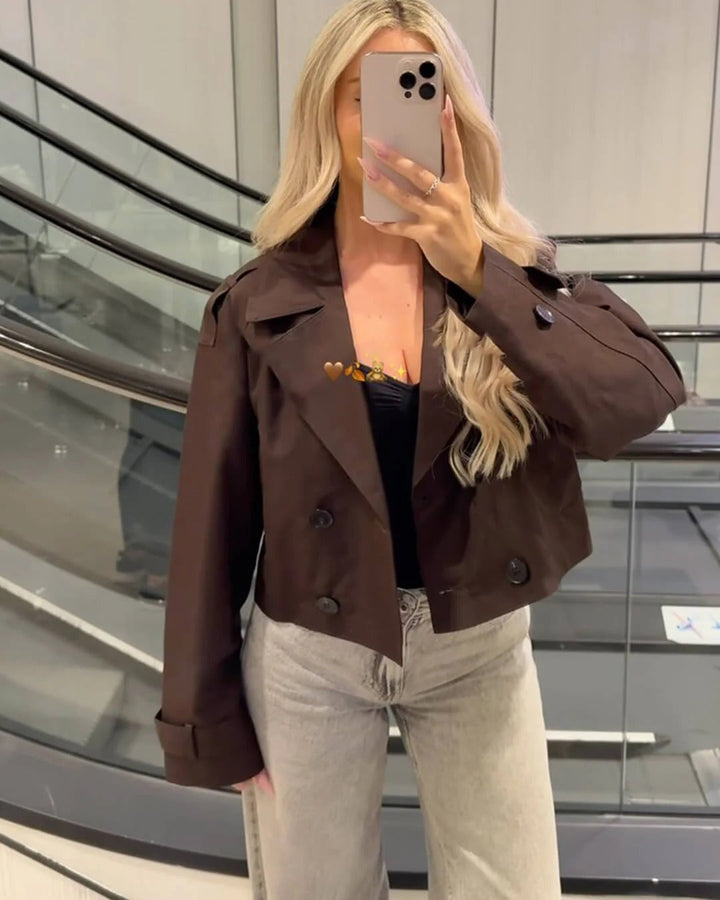 Modern chic women's short double-breasted trench coat. Perfect for a stylish and elegant spring outfit.