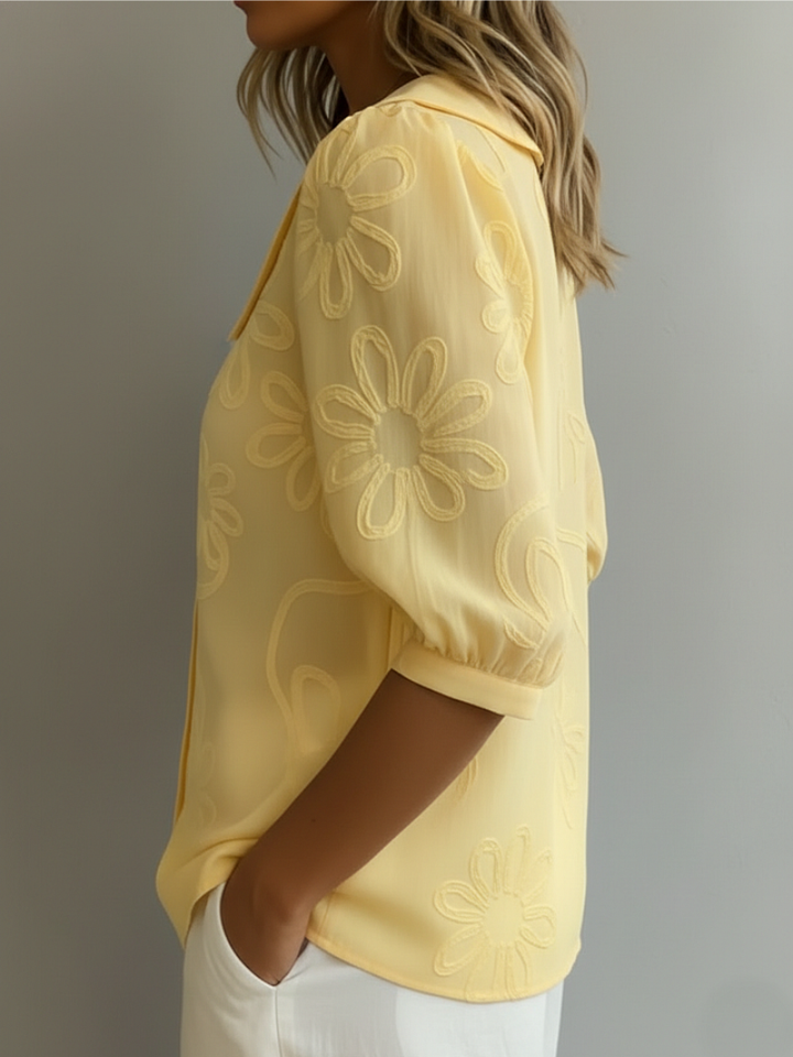 Elegant women's blouse with intricate floral embroidery, featuring short sleeves and a relaxed fit.