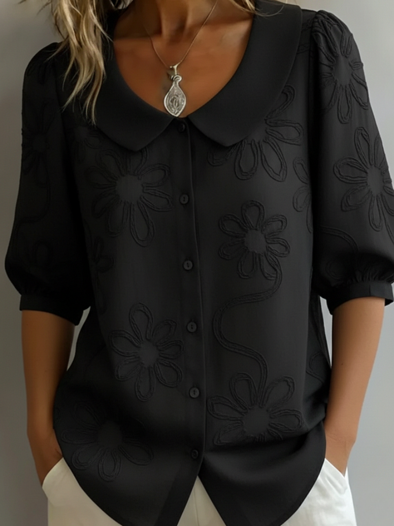 Stylish women's spring/summer blouse, a relaxed fit top with vibrant floral embroidery.