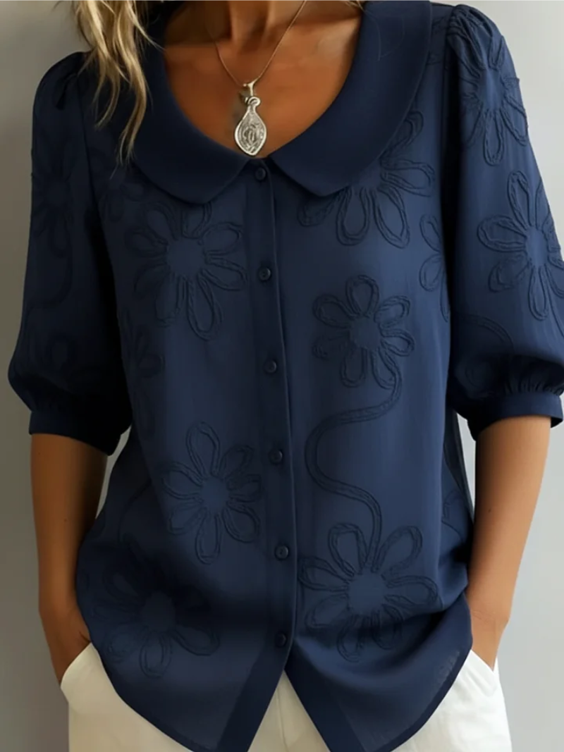 Embroidered floral women's blouse, a versatile short sleeve top for elegant or casual occasions.