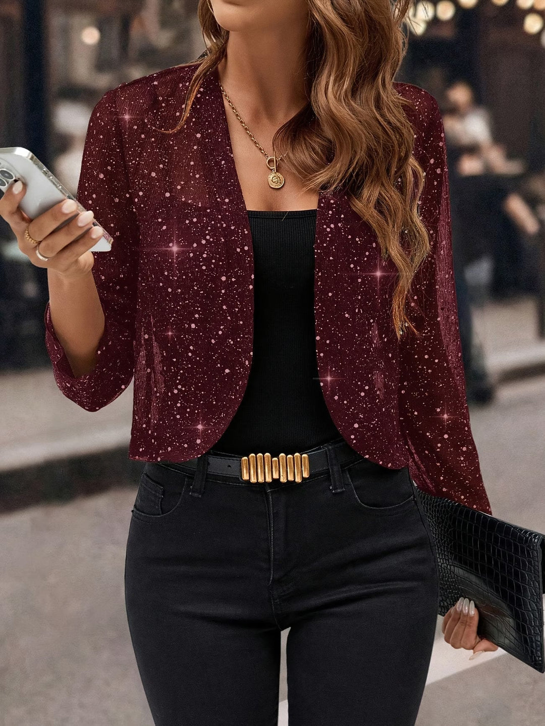 Close-up of a women's glitter sequin cardigan jacket, highlighting the sparkling texture and fashionable detail.