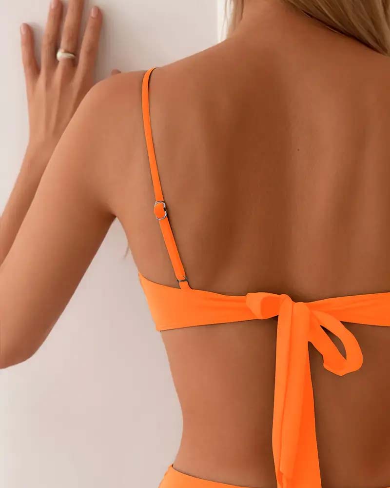 Chic high-waisted women's bikini. Two-piece swimsuit with flattering pleats and gold clasp.