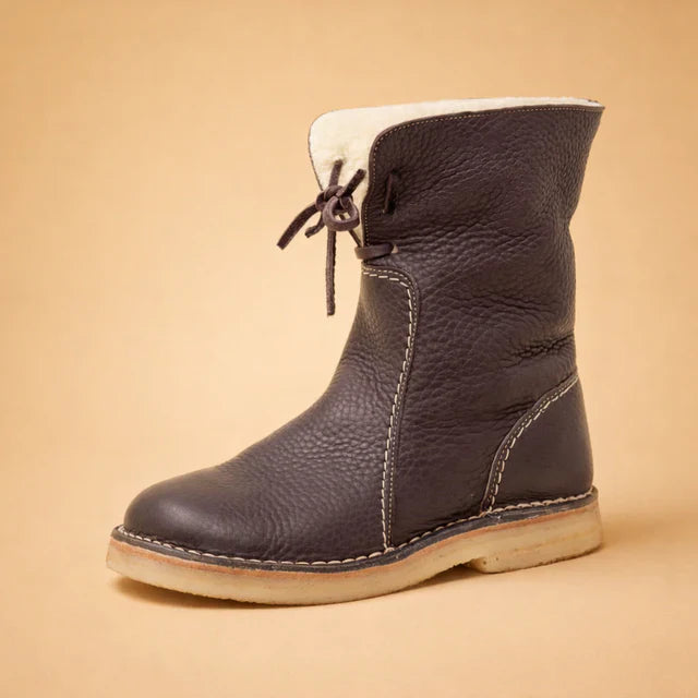Close-up of comfortable women's ankle boots with secure lace-up closure.