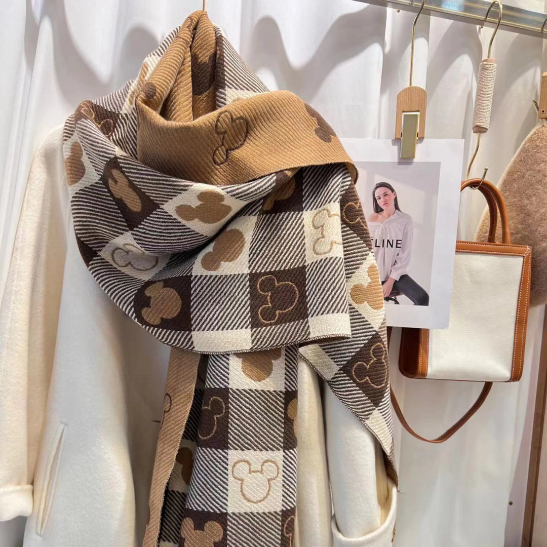 Stylish women's reversible plaid scarf featuring Mickey Mouse, with cozy fringed ends.