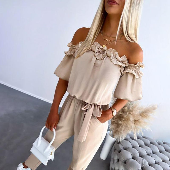 Women's stylish off-shoulder tie-waist jumpsuit with frill detail, perfect for elegant summer fashion.
