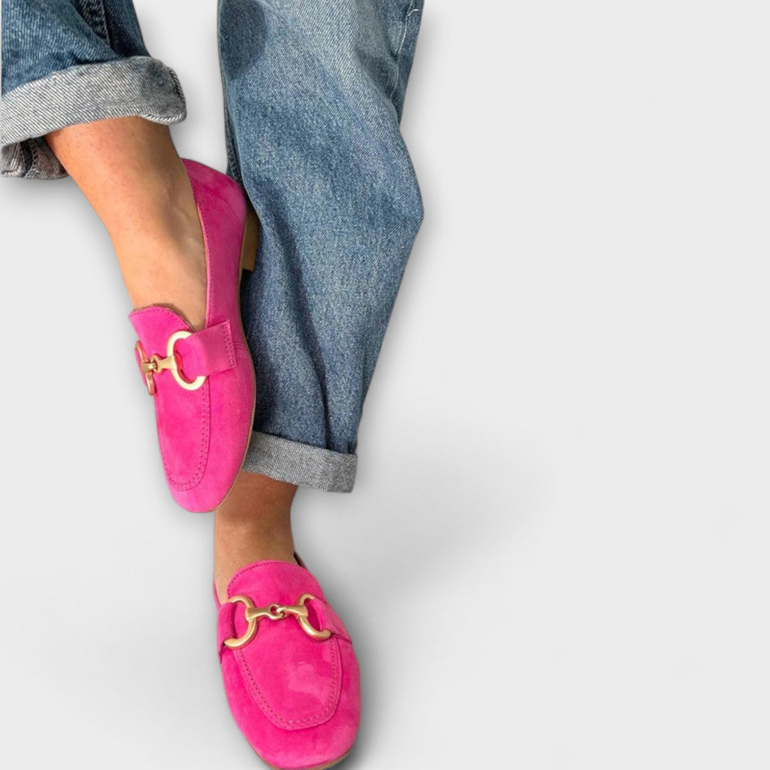 Women's stylish pink slip-on loafers with elegant buckle detail, perfect for casual everyday comfort.