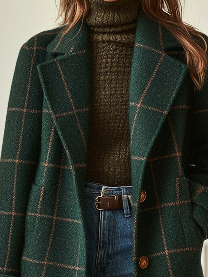 Dark green plaid mid-length winter coat for women. Features a sophisticated double-breasted design & notched lapel.