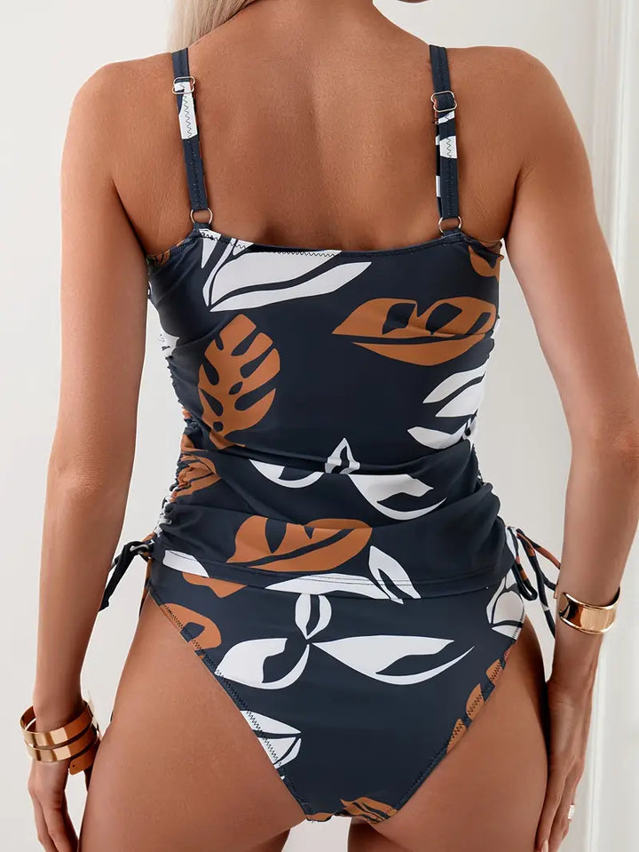 Close-up of women's patterned tankini top with adjustable straps, perfect summer swimwear.