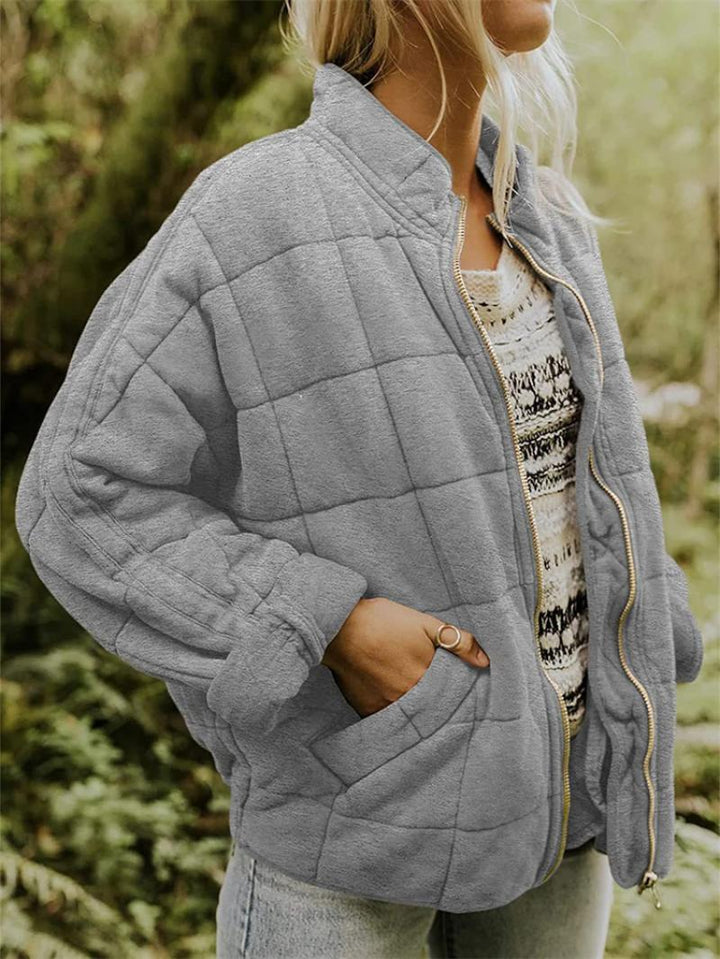 Chic women's quilted bomber jacket. Zip-up, stand collar, and patchwork design for everyday spring outerwear.