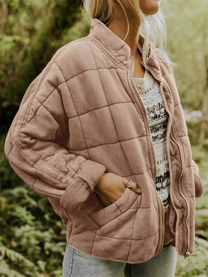 Women's zip-up quilted bomber jacket. Modern, stylish outerwear for spring or autumn everyday fashion.