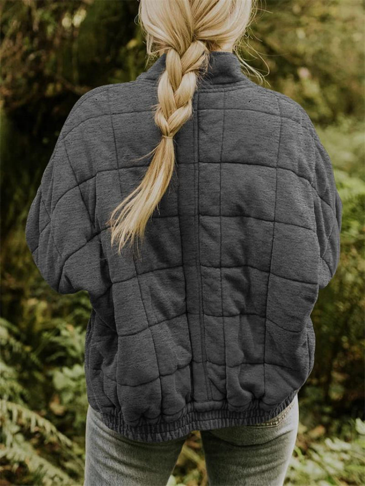 Patchwork design women's quilted bomber jacket. Zip-up, stand collar for a stylish, casual autumn look.