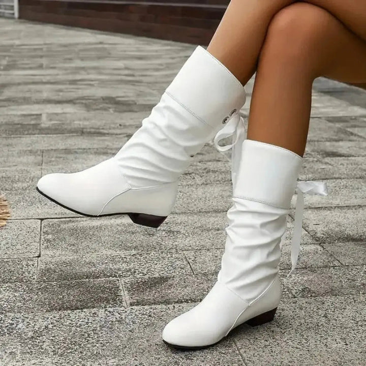 Comfortable women's mid-calf boots with elegant ruched design and ribbon lace-up.
