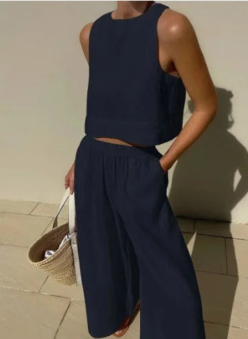 Matching women's stylish two-piece set featuring a sleeveless crop top and flowy wide-leg pants.
