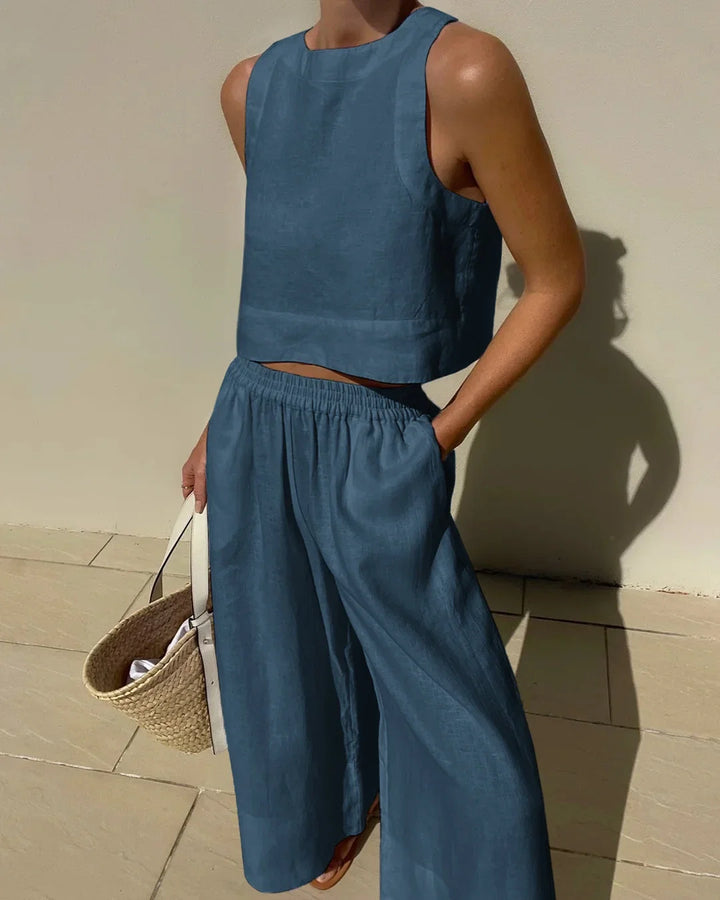 Stylish women's summer outfit: matching sleeveless crop top & wide-leg pants two-piece set.