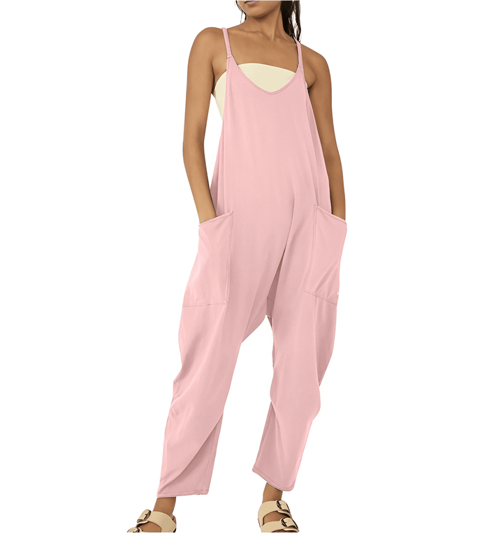 Full body shot of woman in stylish sleeveless jumpsuit with pockets. Summer fashion.