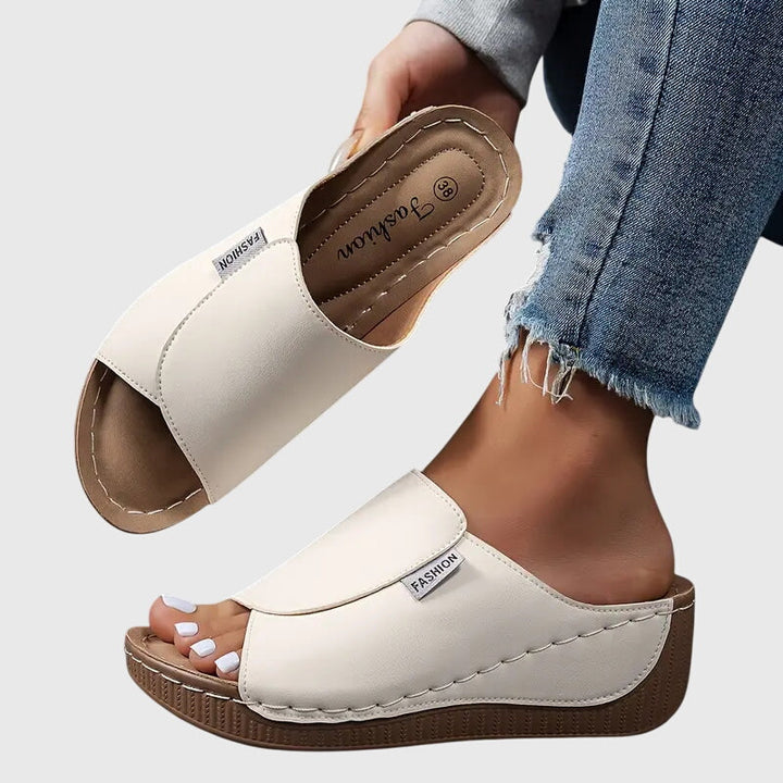 Women's fashionable stitched wedge sandals, combining comfort & style for summer footwear.