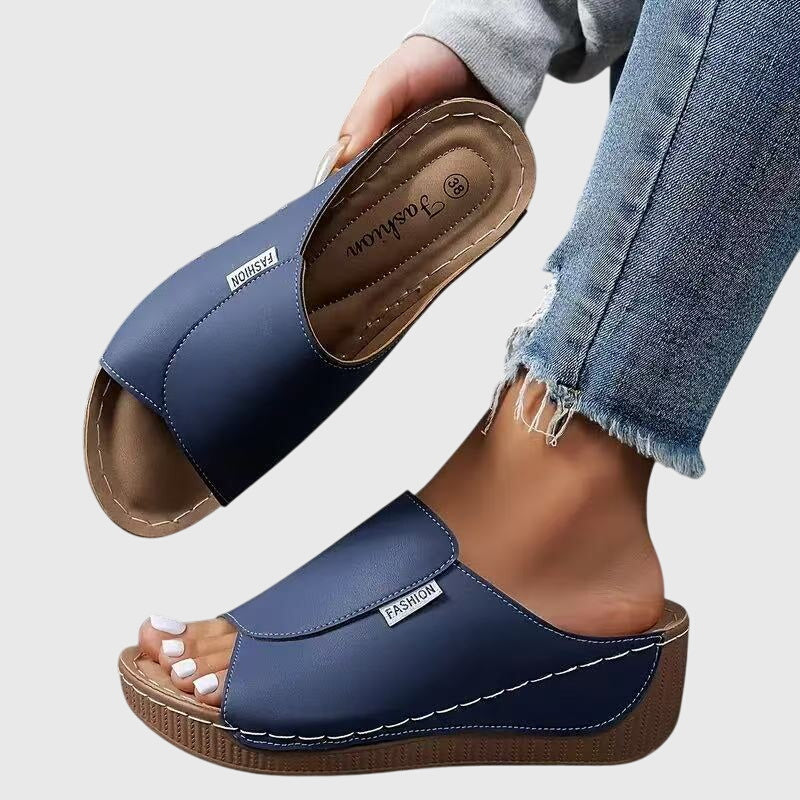 Comfortable women's slip-on wedge sandals with a chic stitched design & open toe.