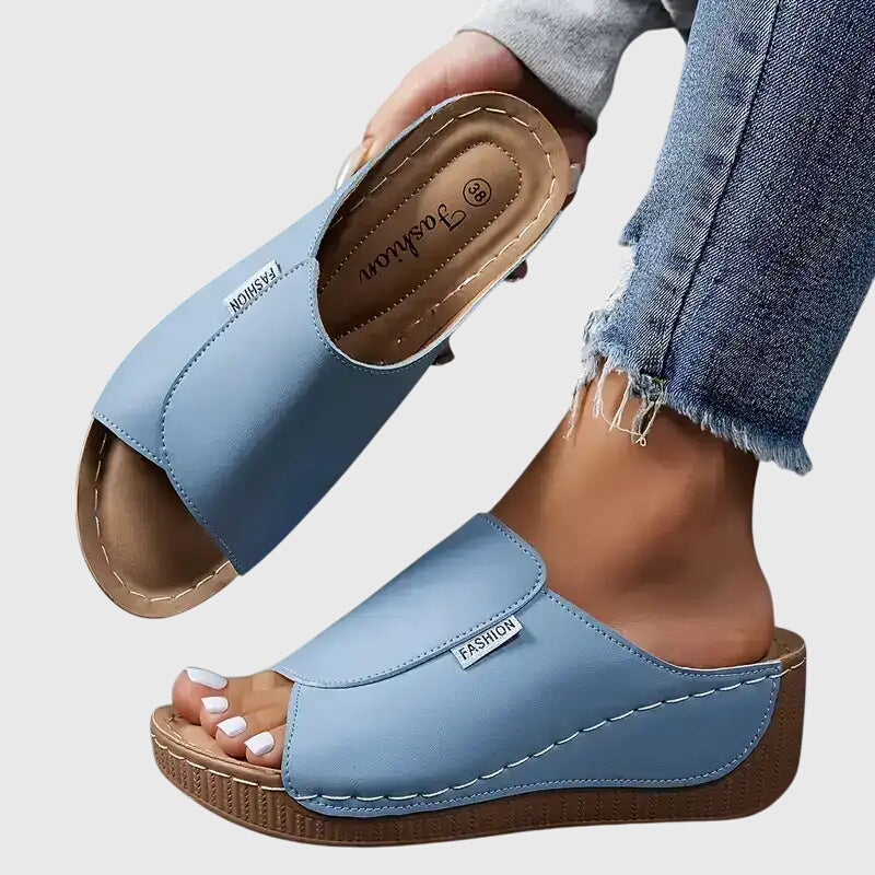 Chic stitched wedge sandals for women, a stylish and comfortable slip-on design.