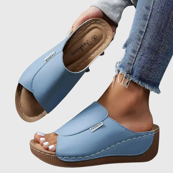 Chic stitched wedge sandals for women, a stylish and comfortable slip-on design.