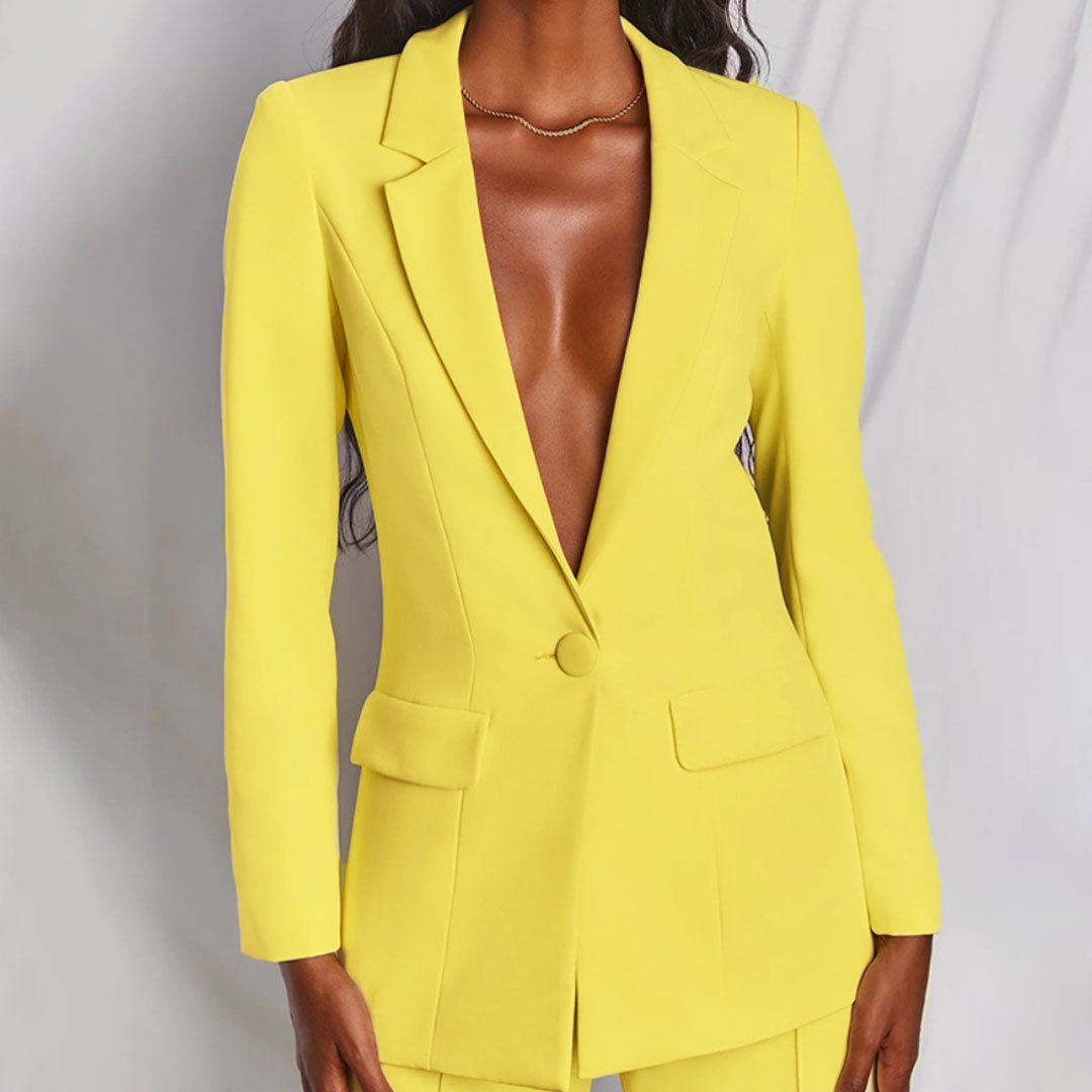 Elegant tailored women's suit featuring a blazer and matching trousers for office fashion.