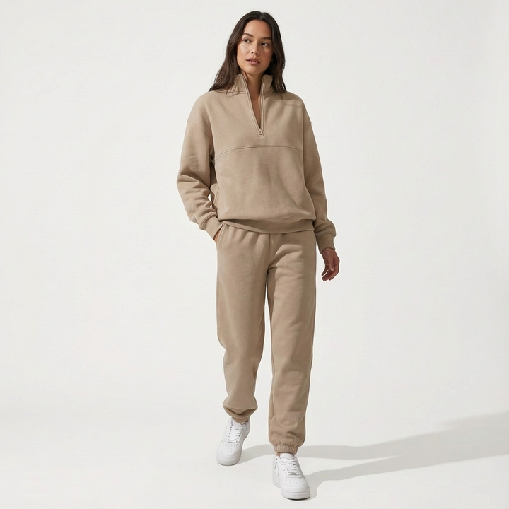 Fashionable women's two-piece activewear set. Half-zip tracksuit with joggers, perfect for travel.